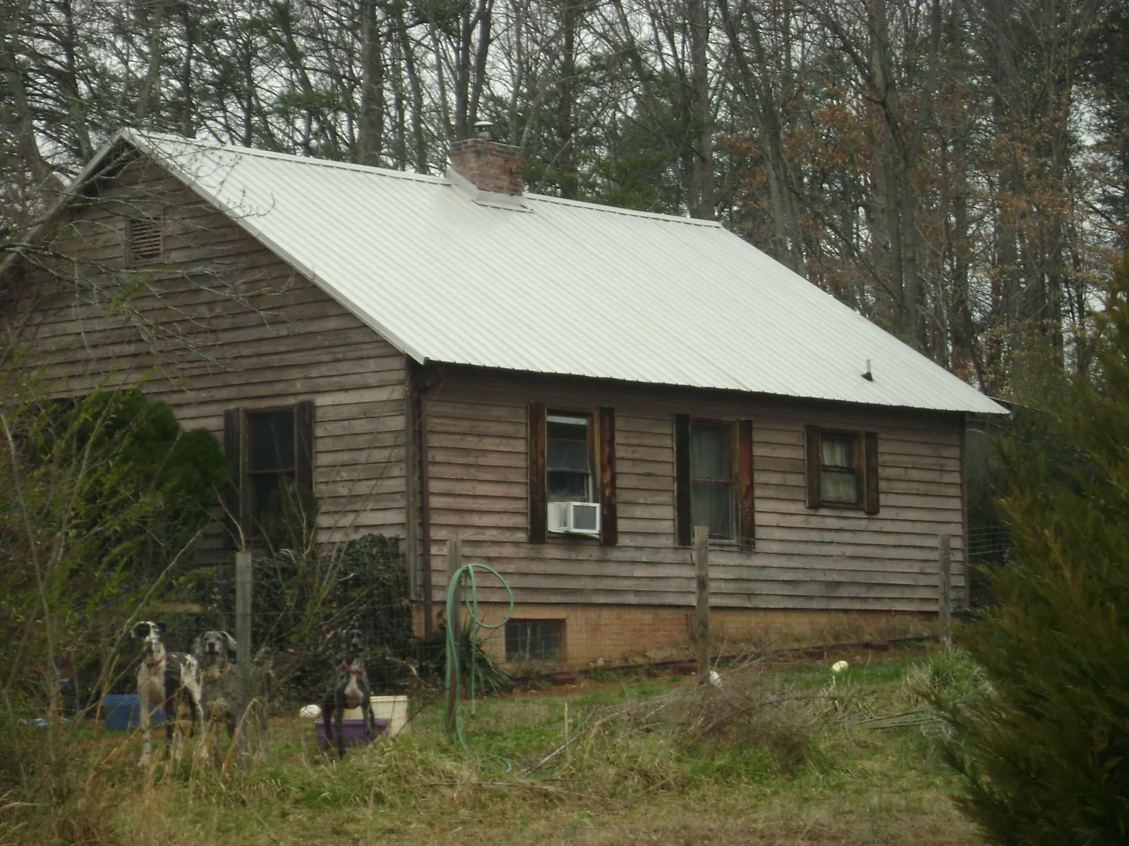 White metal roof on an old wood sided farmhouse, from a Asphalt Shingle Roof Repair job in Montgomery